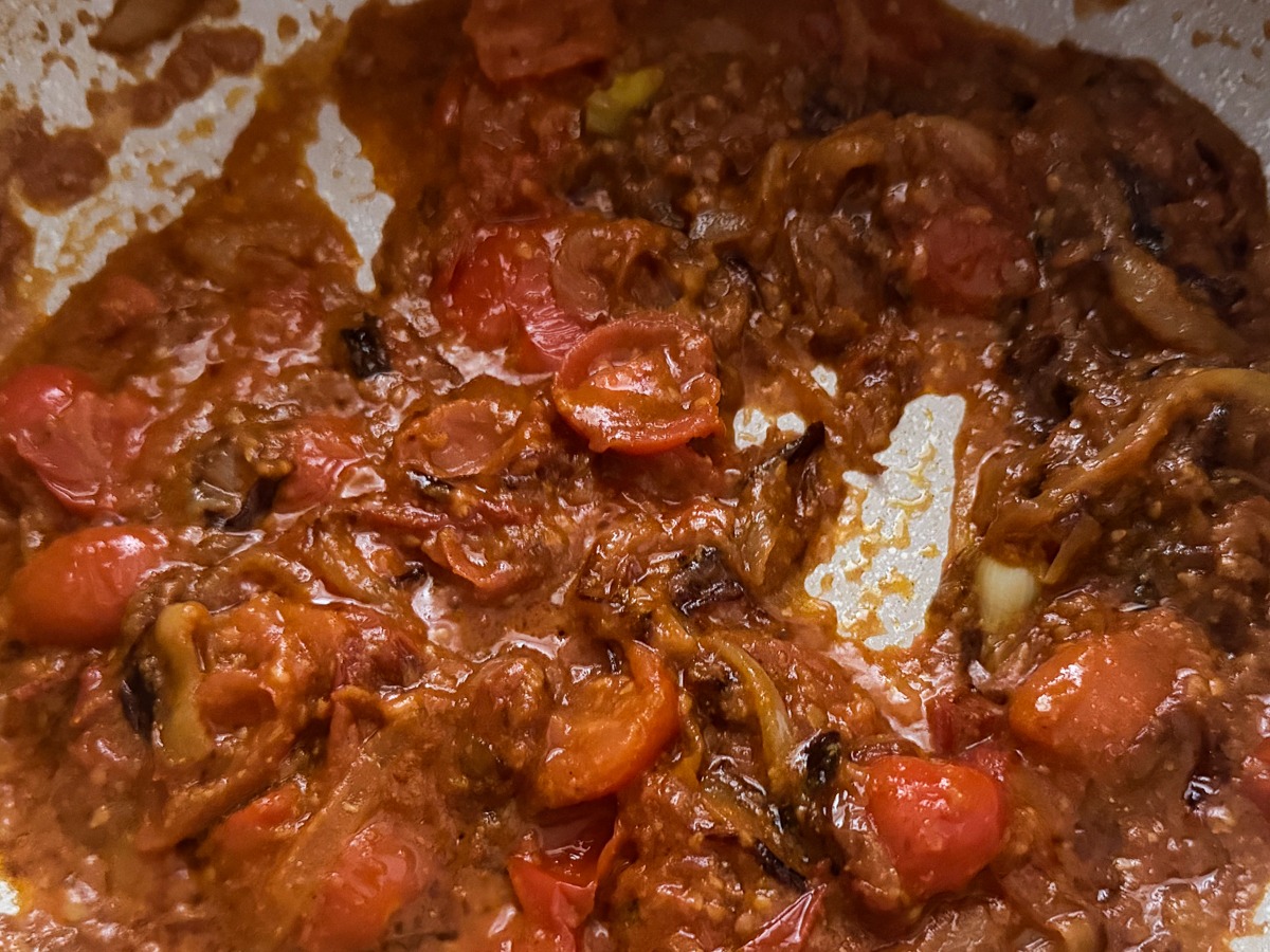 fry tomatoes until they break down and get a jammy texture