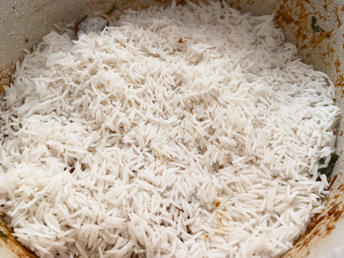 rice layered on top of the prawn masala 