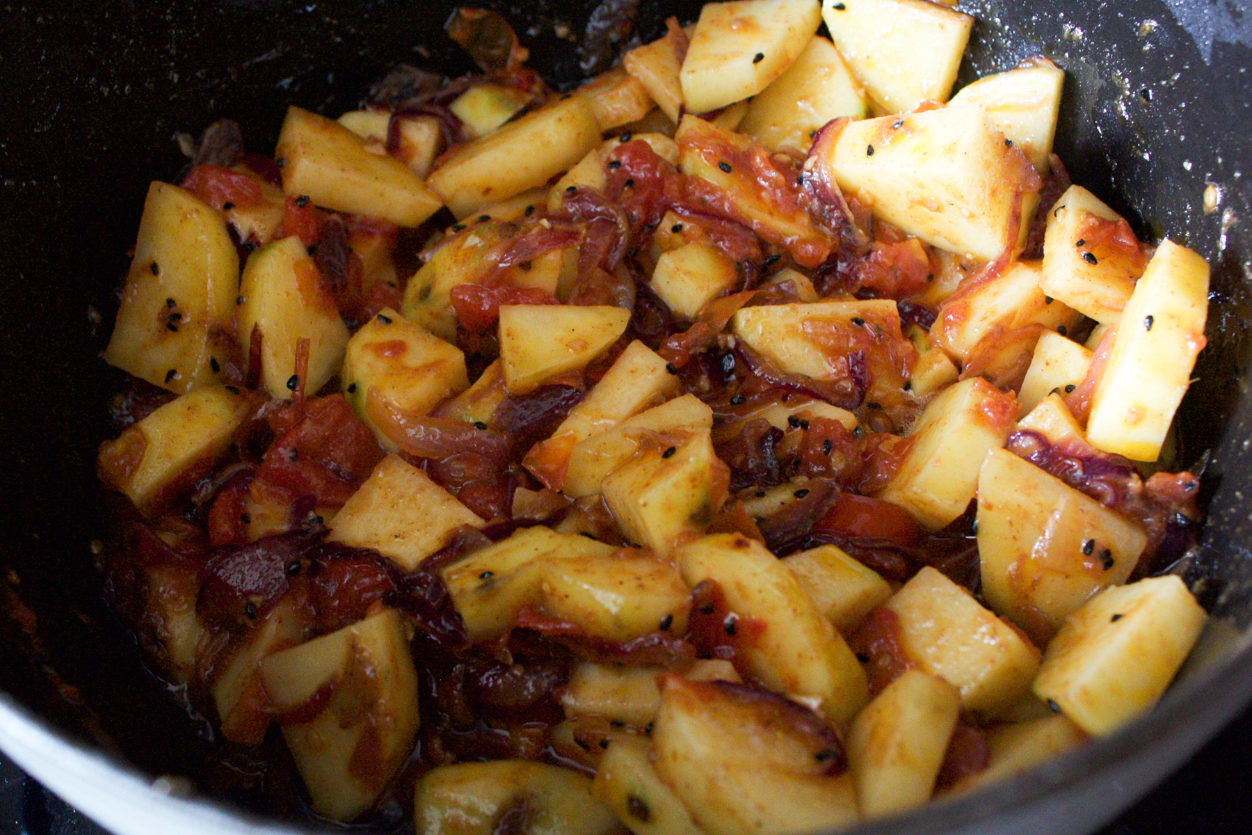 Adding potatoes to curry