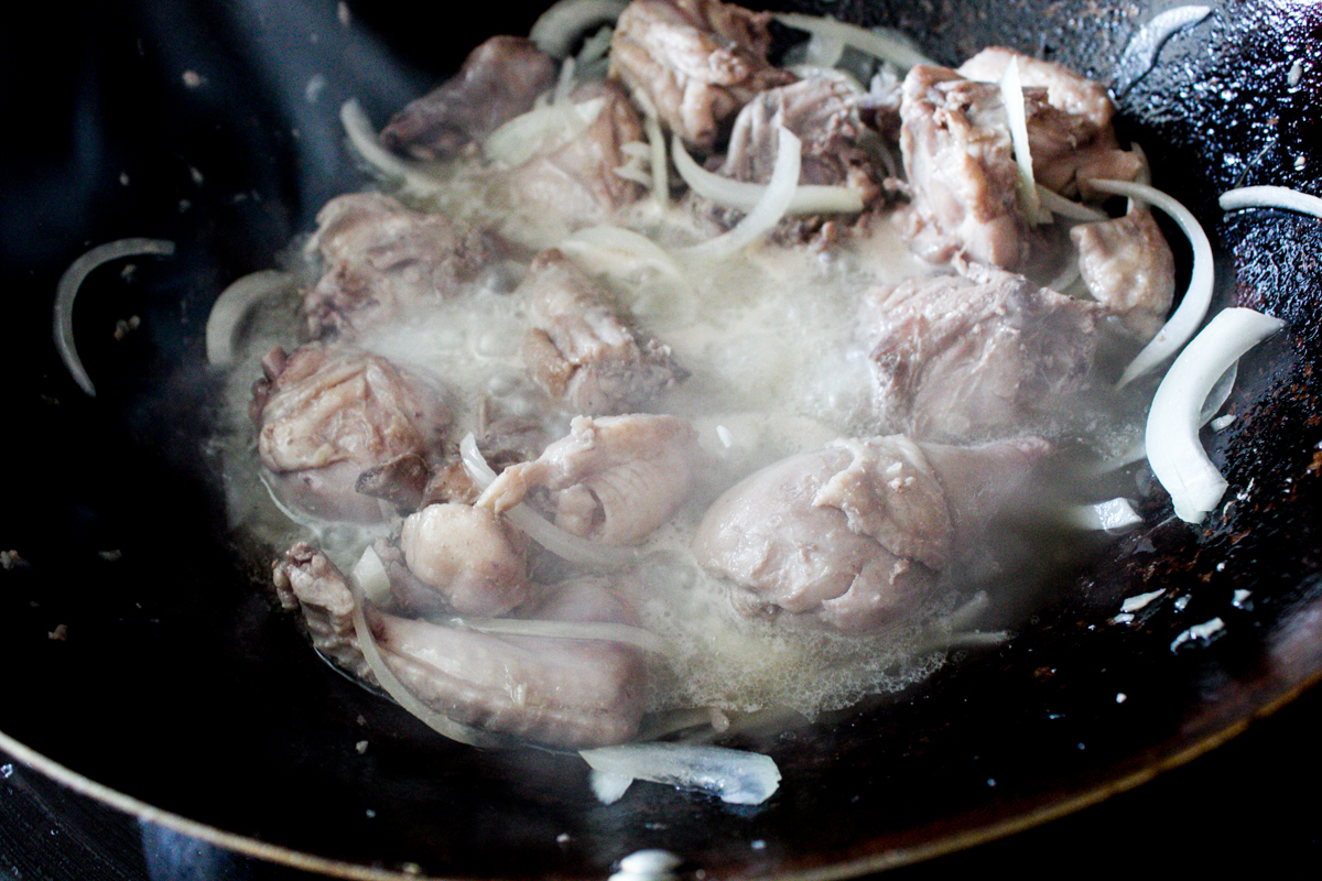 bringing chicken to simmer with onion, water, crushed ginger