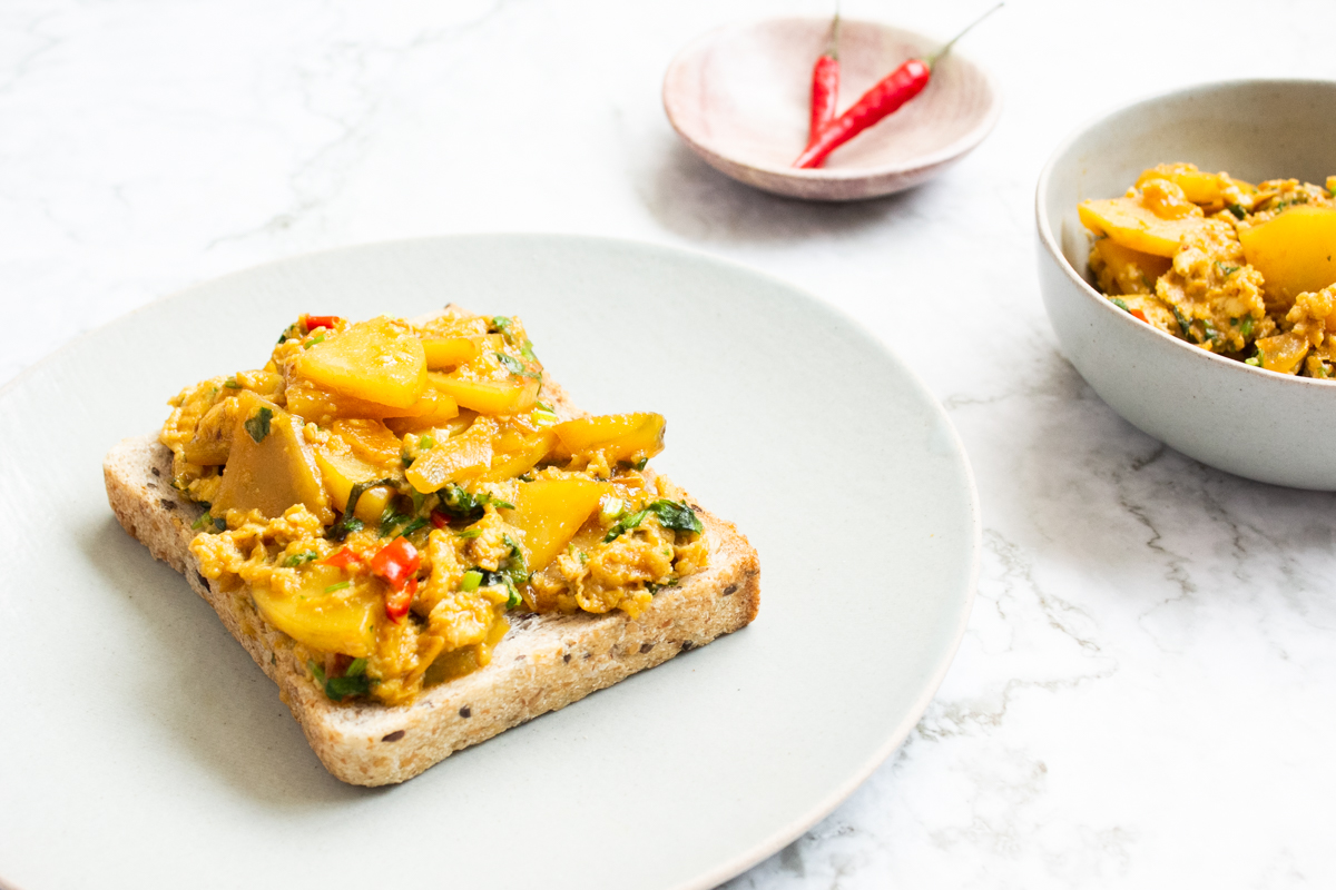 Scrambled eggs with potatoes on toast