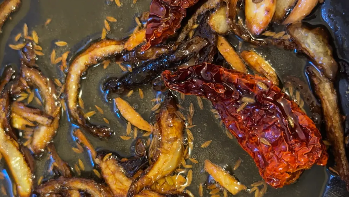 tadka of onion, cumin seeds, garlic and dried red chile 