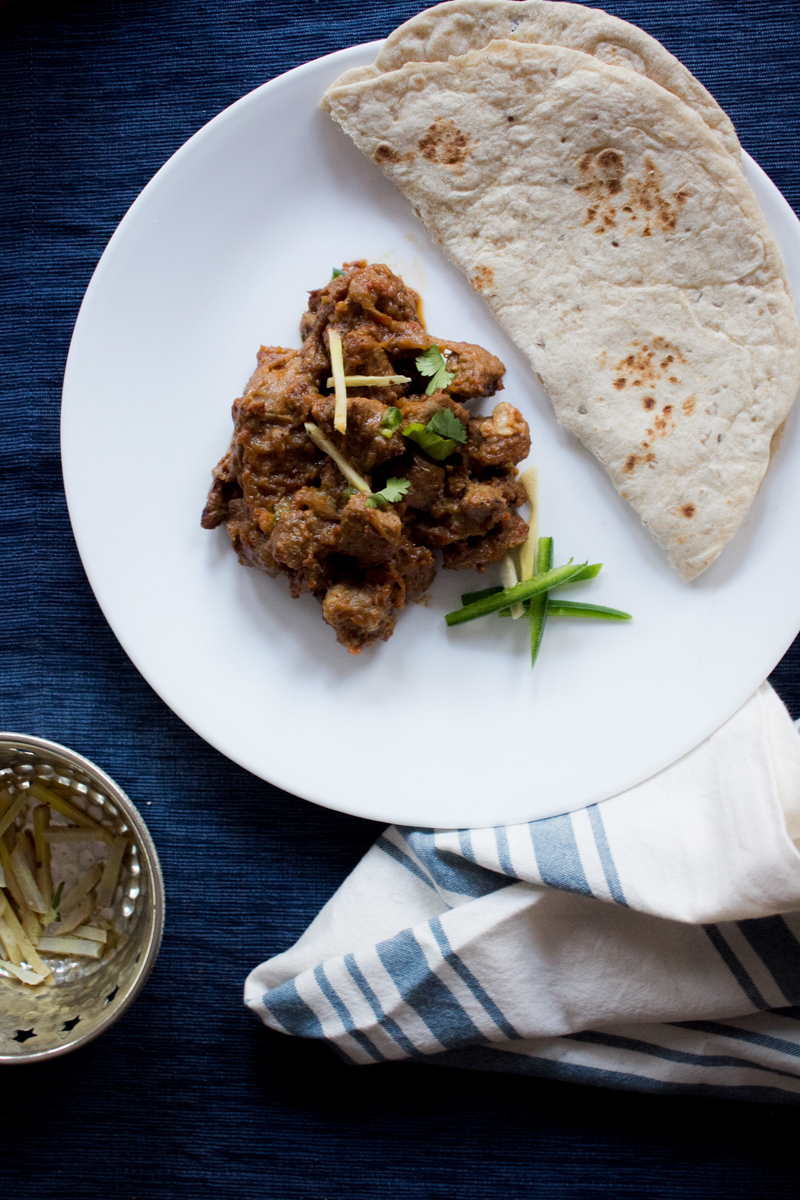 bhuna gosht on a plate with roti