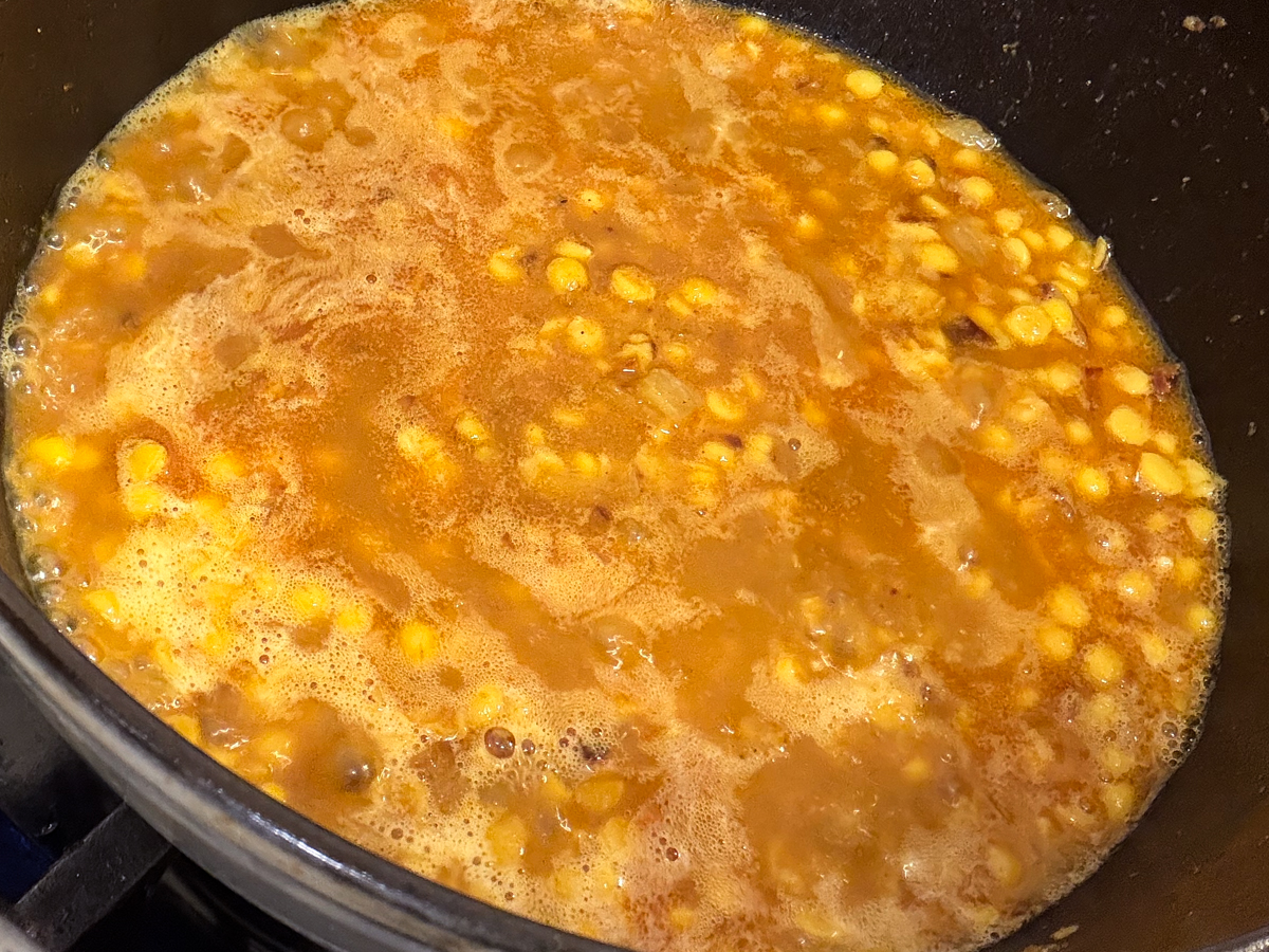 Dal stirred in the tomato, onion and spice mixture