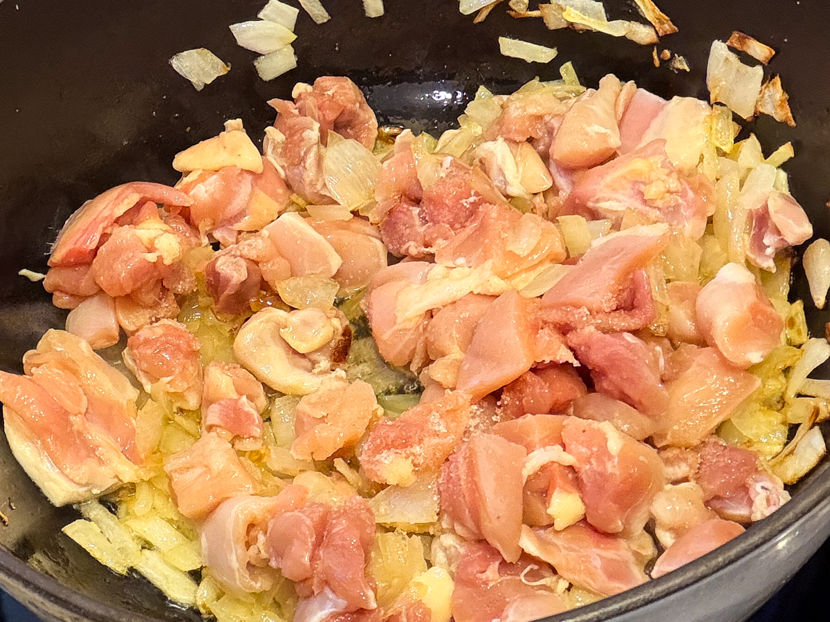 Chopped chicken added to browned onions 